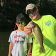 Kevin Sinyard and his grandson show off a fish