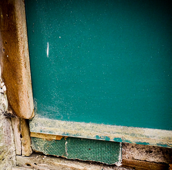 asbestos cement spacer behind chalkboard