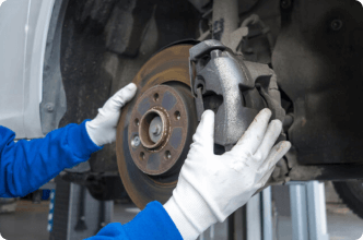 Auto mechanic handling an asbestos brake pad