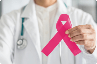 Doctor holding up breast cancer ribbon