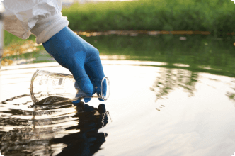 Scientist collects contaminated water for testing