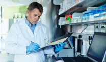 Technician documenting notes in a lab