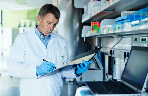 Technician documenting notes in a lab