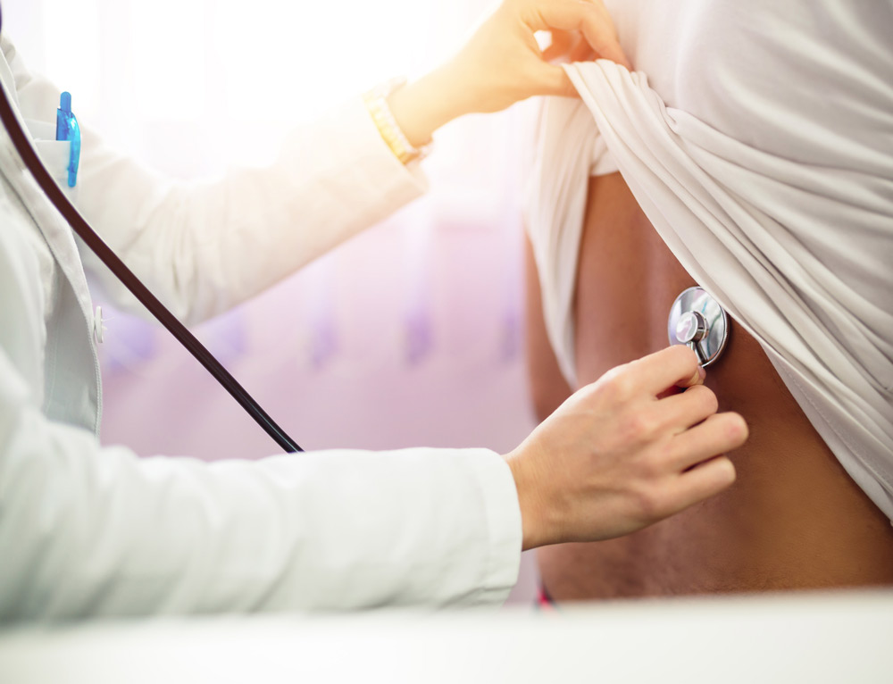 Doctor checking lungs with stethoscope