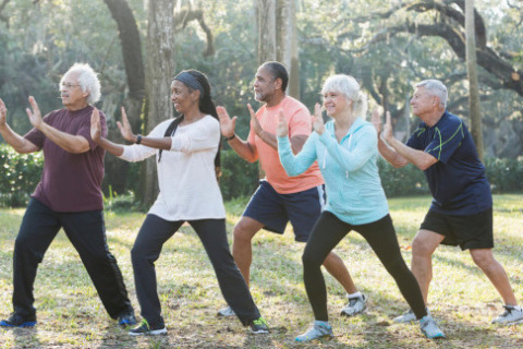 Mesothelioma patients practicing tai chi in a park