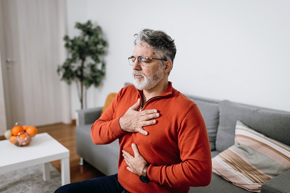 Man with hand on chest