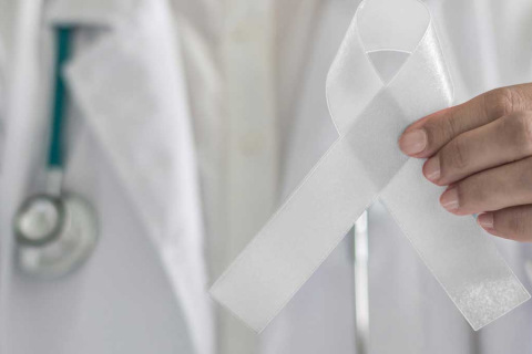 Mesothelioma ribbon held up by doctor