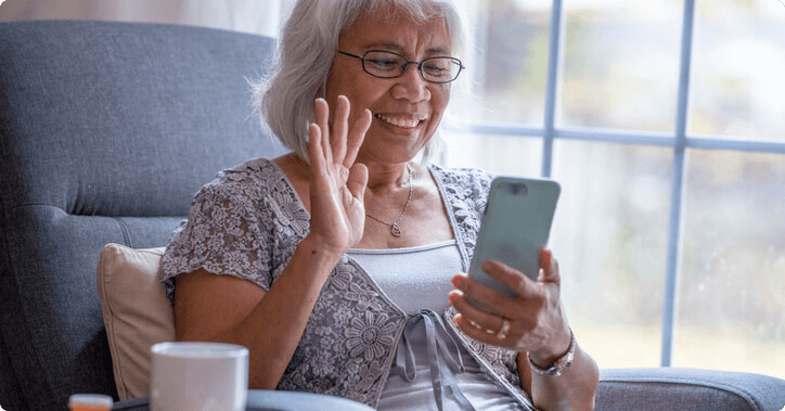 Older woman on a video call on her phone