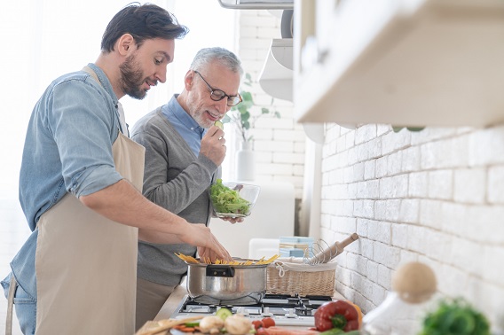 Son helping his father prepare a meal